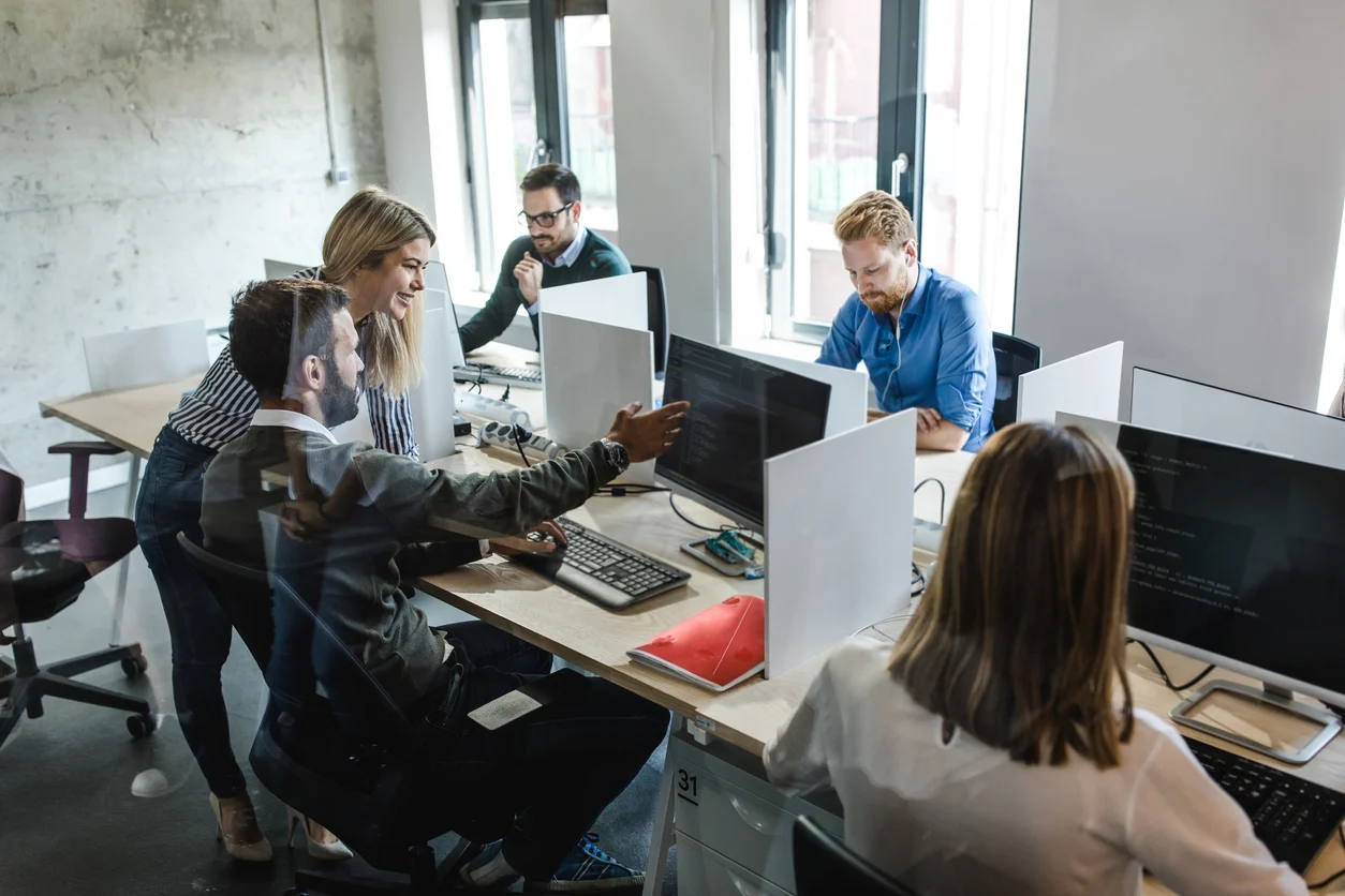 Co-managed IT specialists collaborating with an internal technology team